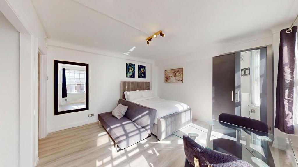 Bright, contemporary bedroom with a plush uphol...