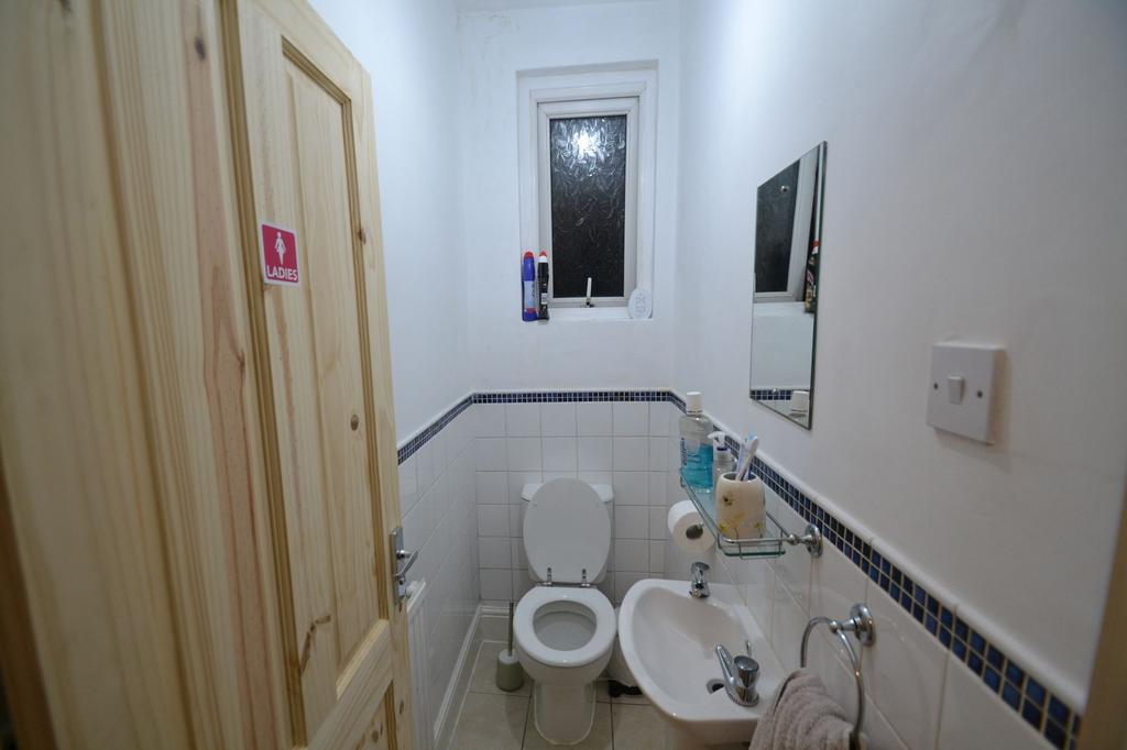 Bright and clean bathroom with a small window, ...