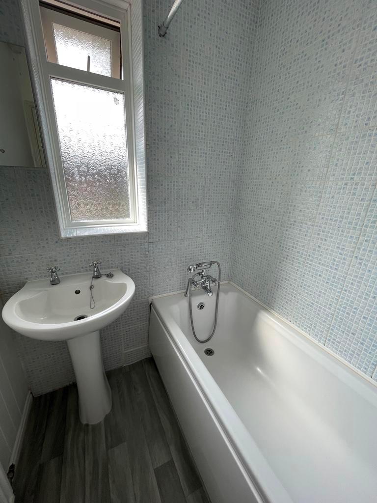 Bright, well-kept bathroom with a full-size bat...