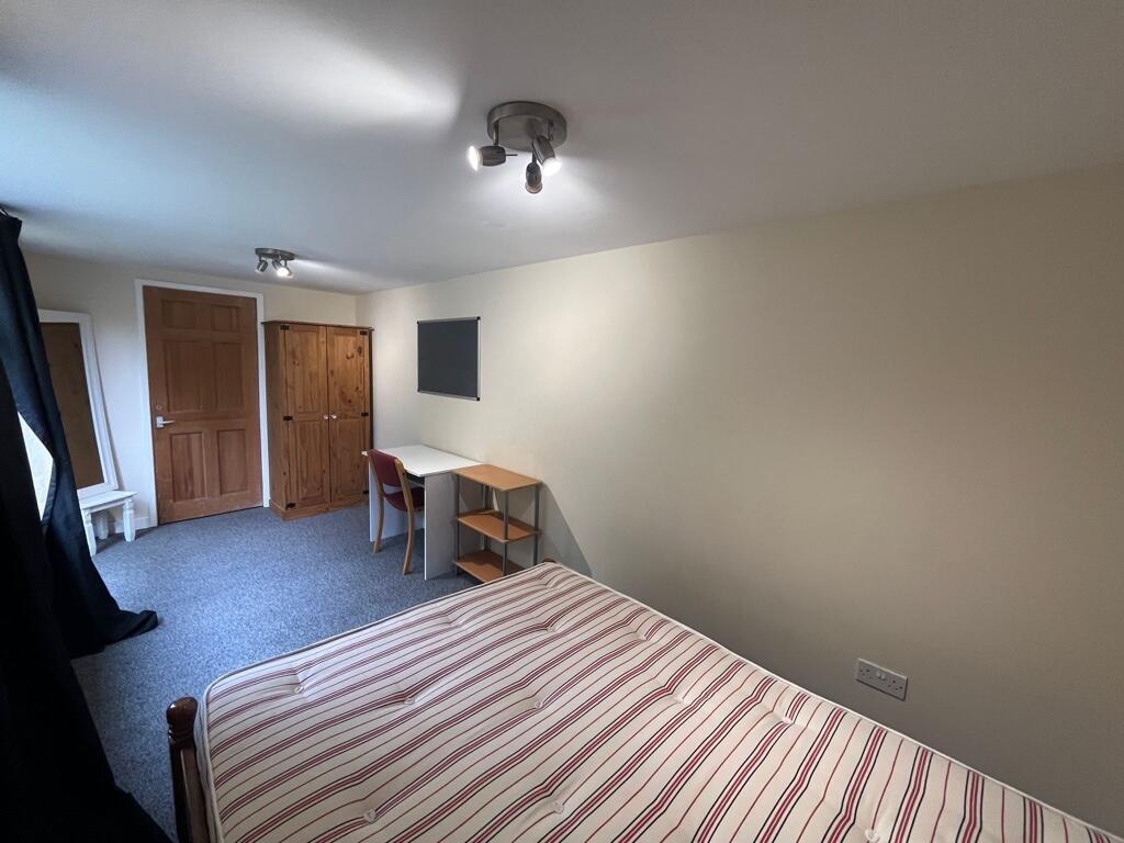 Bright, neatly presented bedroom with a double ...