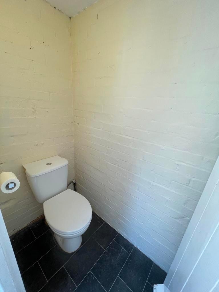 Compact toilet room with a modern close-coupled...