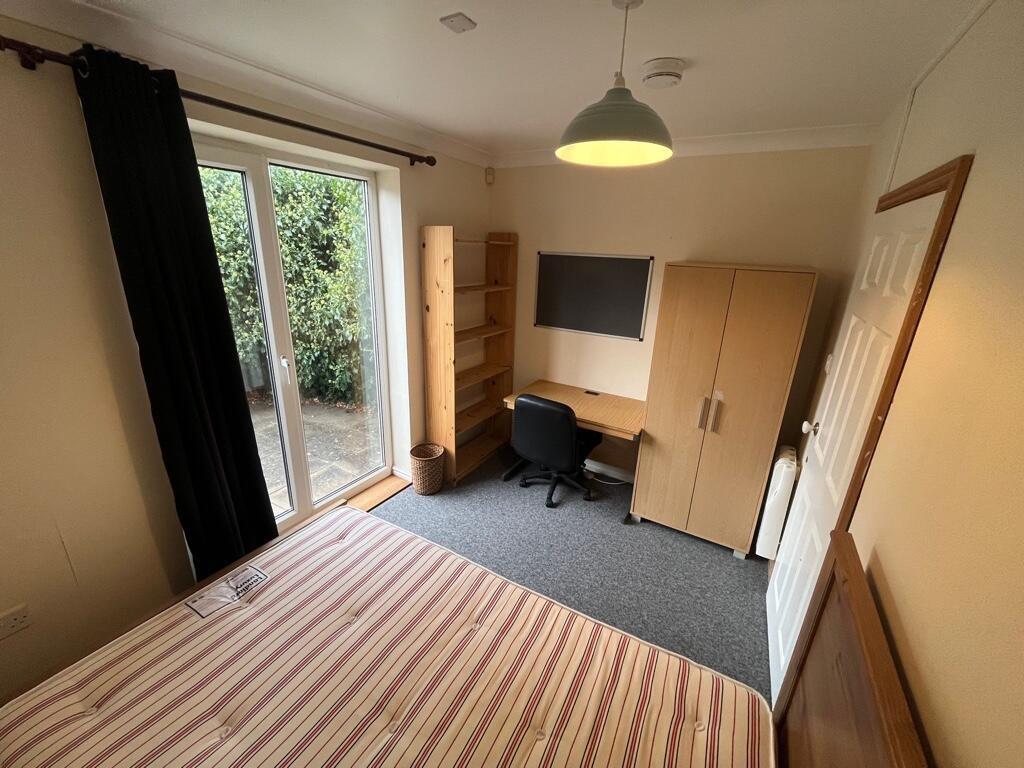 Bright double bedroom with large patio doors op...