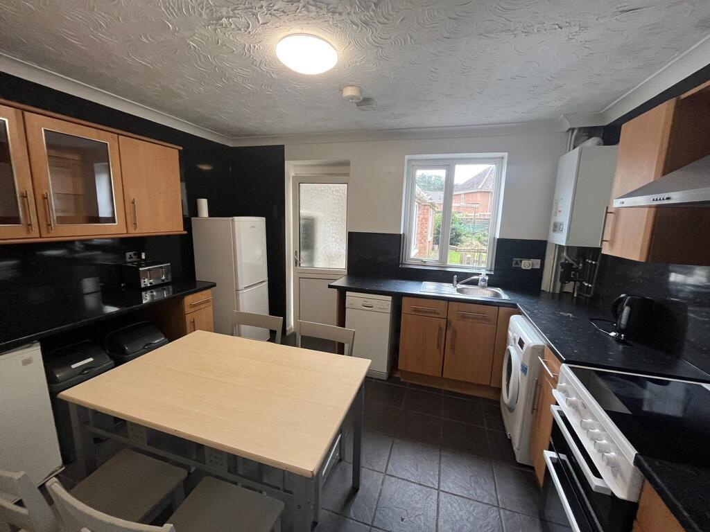 Well-equipped modern kitchen with wooden cabine...