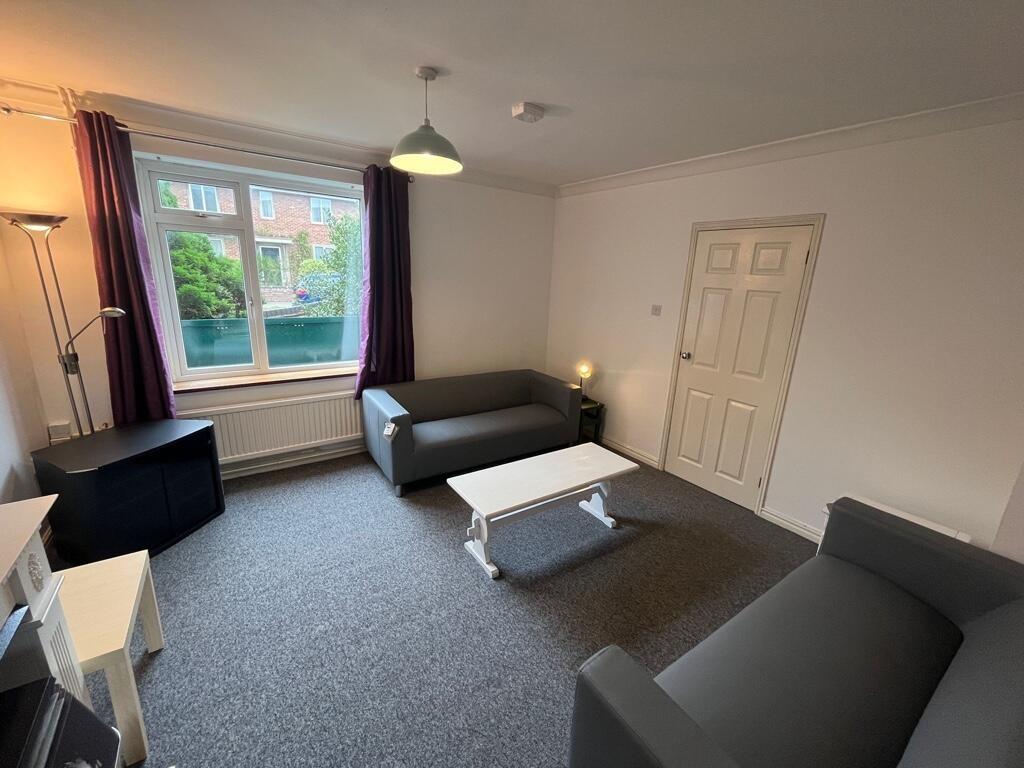 Bright, neatly presented living room with two m...
