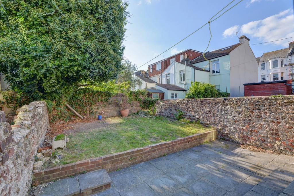 Sunny private rear garden with a paved patio le...