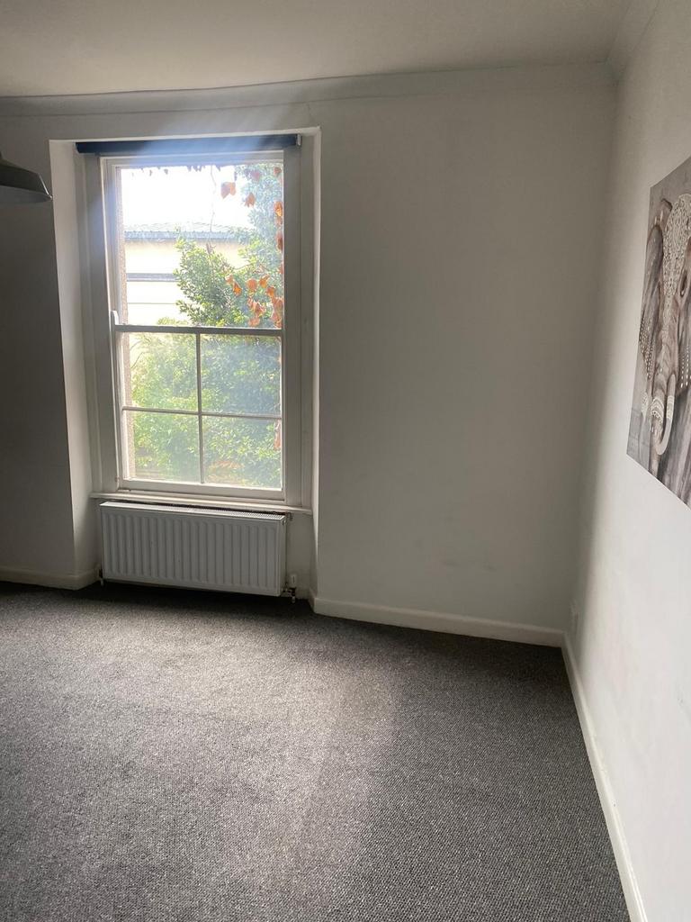 A cozy, well-maintained bedroom featuring a lar...