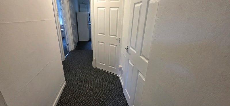 Well-maintained internal hallway with neutral w...