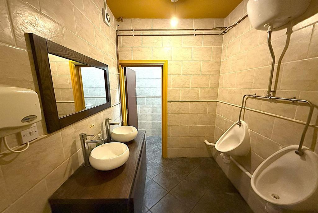 Clean modern shared washroom with dual sinks...