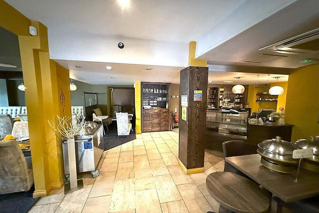 Spacious, modern communal lounge with dining ar...