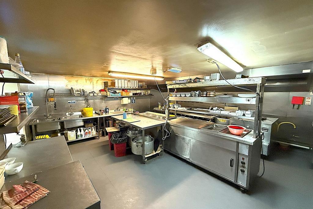 Well-equipped commercial kitchen with stainless...