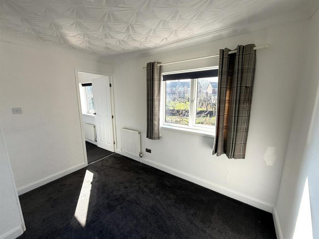 Bright bedroom with large window and neat finis...