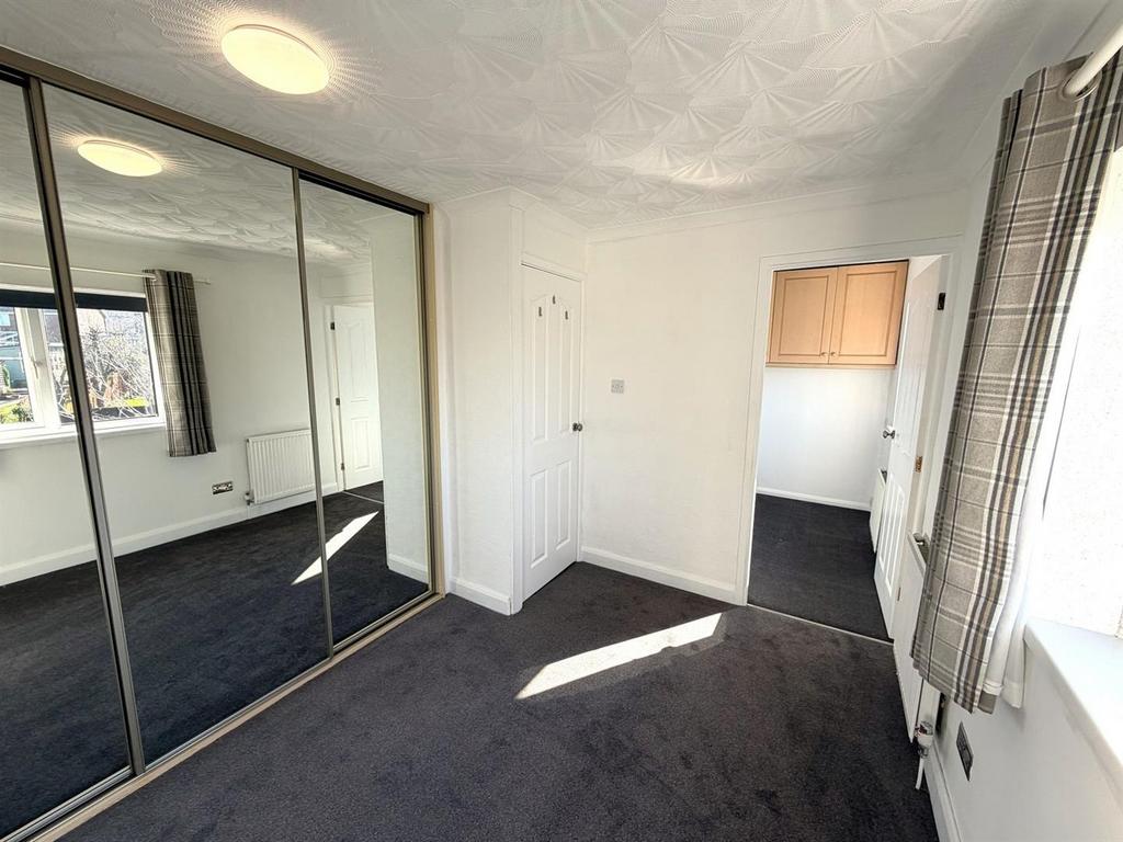 Bright bedroom with mirrored fitted wardrobes...
