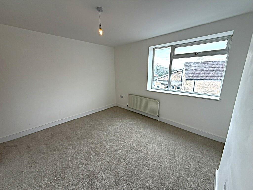 Bright, neutral double bedroom with street view...