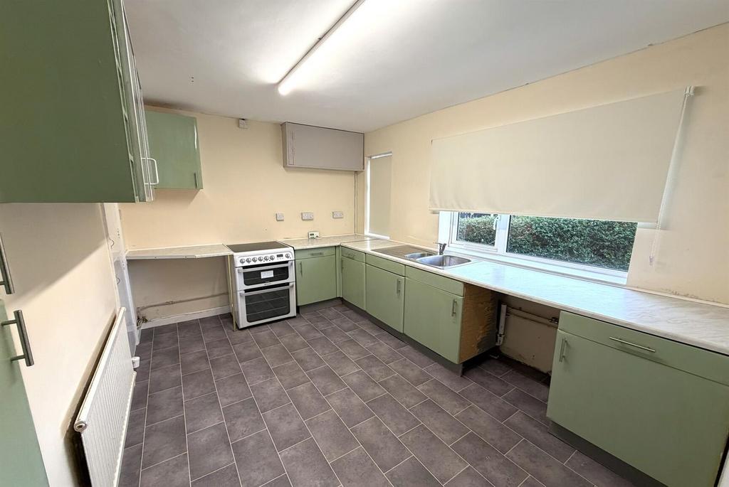 Bright kitchen with worktops and cooking range...