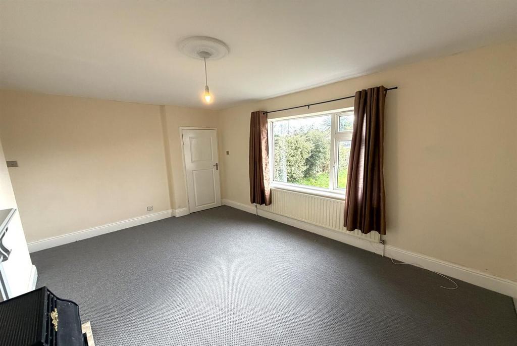 Bright, spacious living room with large window...