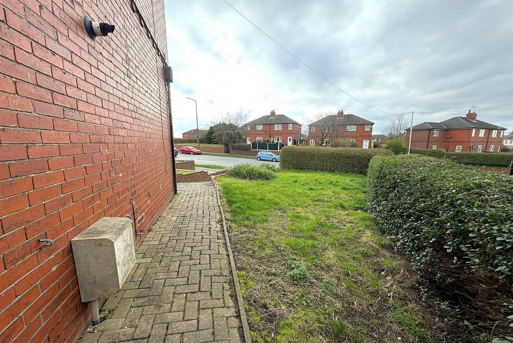 Front path with hedged lawn and street view...