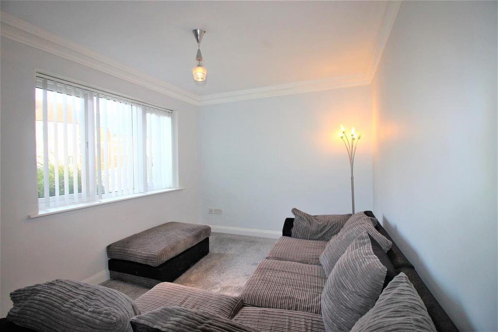 Bright lounge with large corner sofa and window...