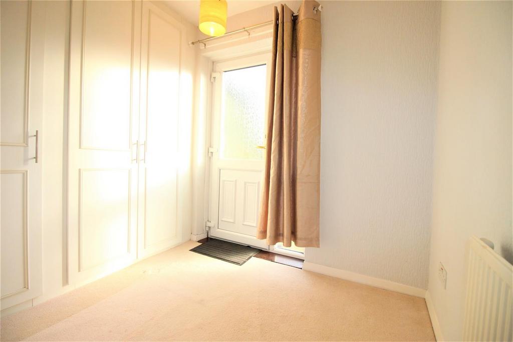 Bright bedroom with built-in wardrobes and wind...