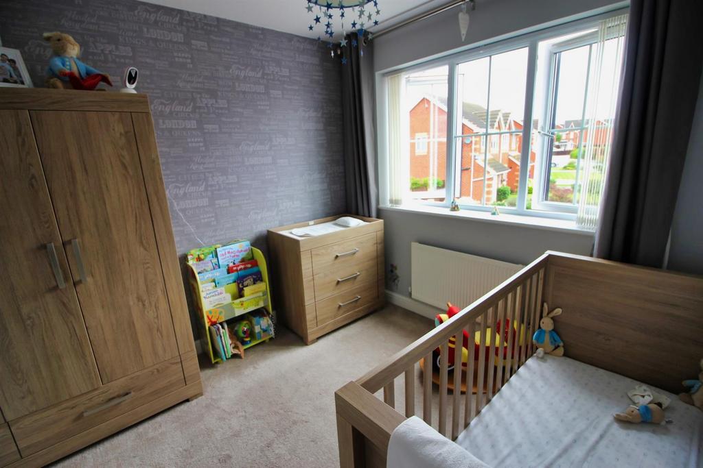 Bright room with large window and wooden furnit...