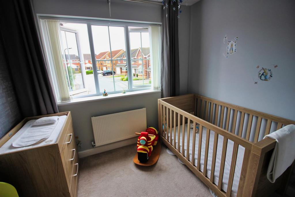 Bright small bedroom with crib and storage...