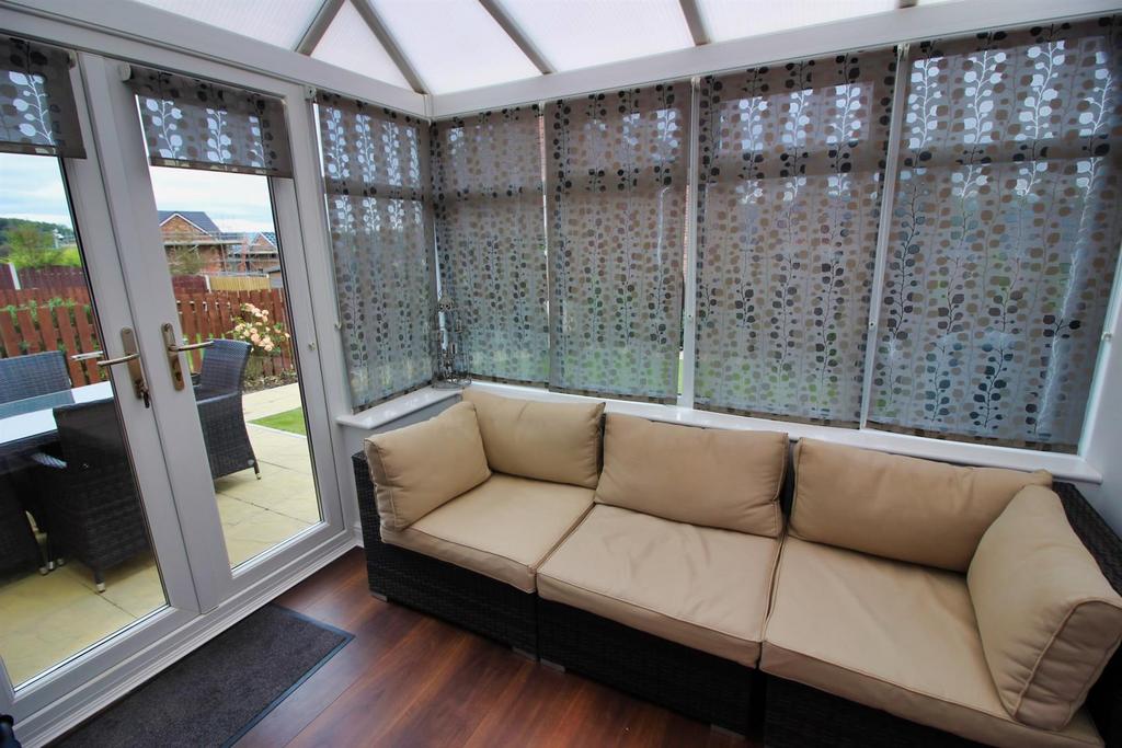 Bright conservatory with comfortable corner sof...