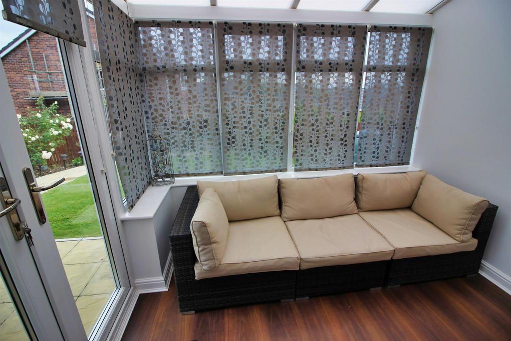 Bright corner lounge with large windows and sof...