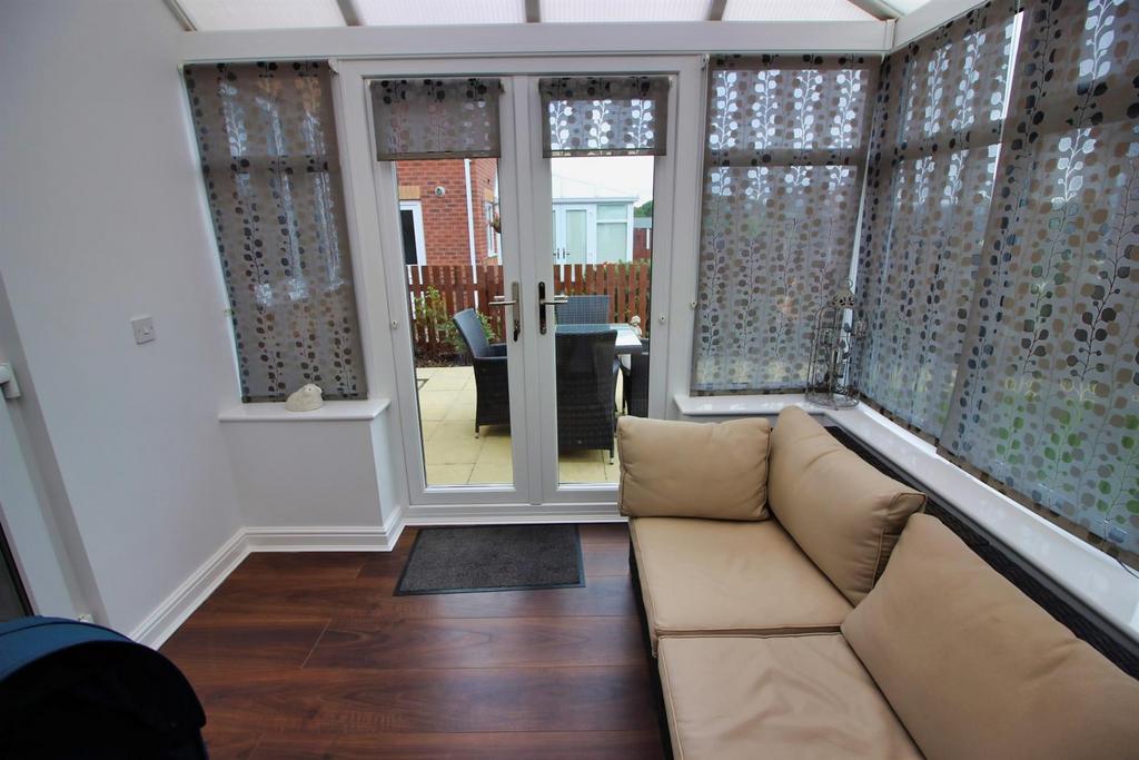 Bright lounge with seating and patio access...