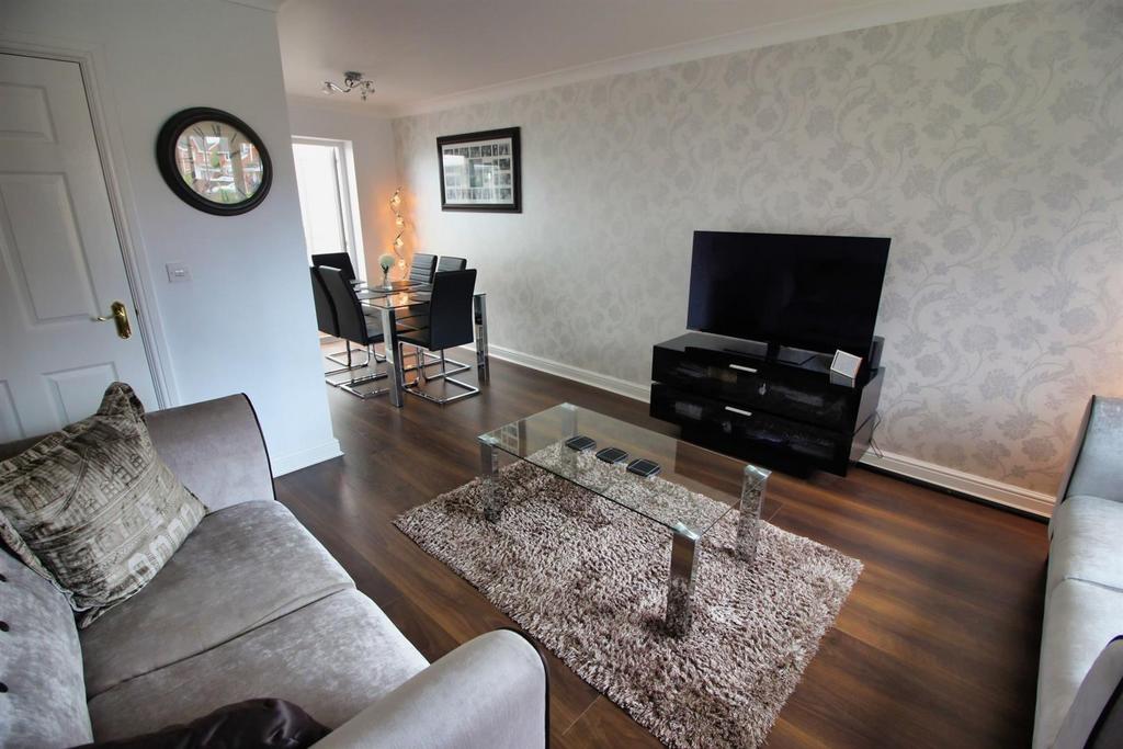Bright, modern lounge with TV and dining area...