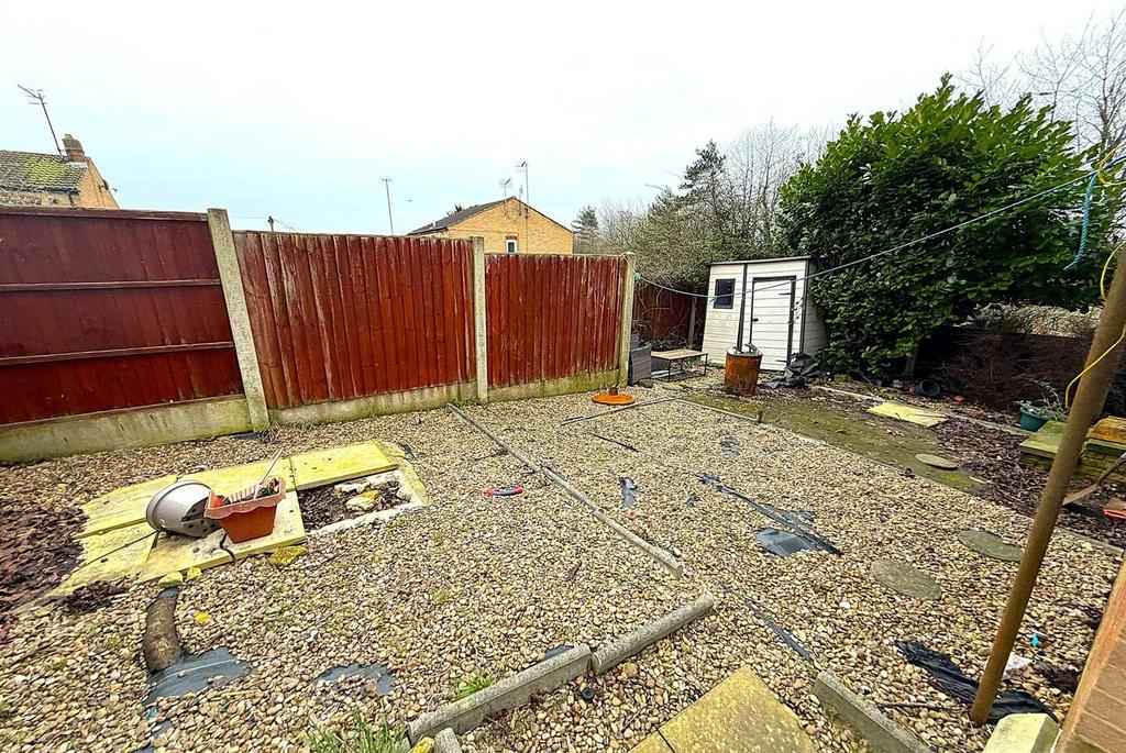 Low-maintenance gravel garden with patio area...