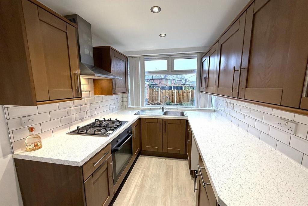 Bright modern kitchen with gas hob and ample wo...