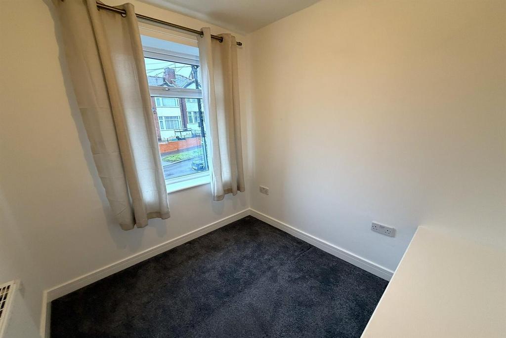 Bright single bedroom with window and neutral d...