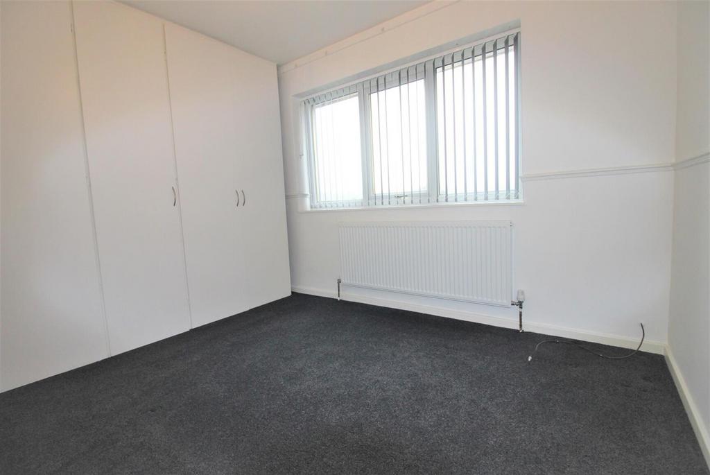 Bright room with built‑in wardrobe and large sa...