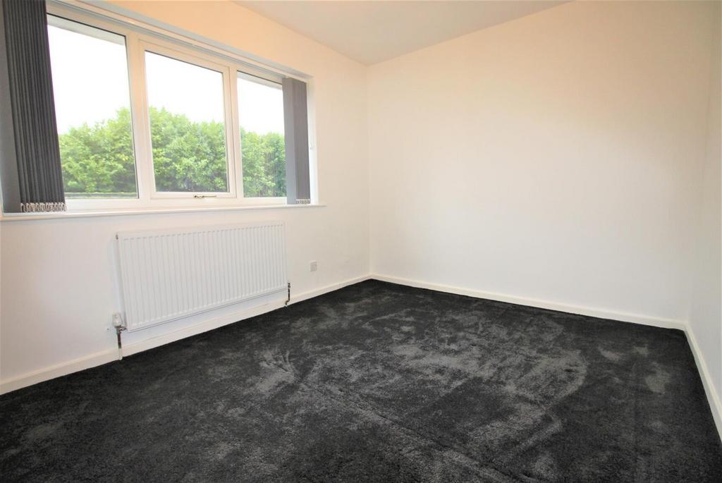 Bright bedroom with large window and fresh deco...