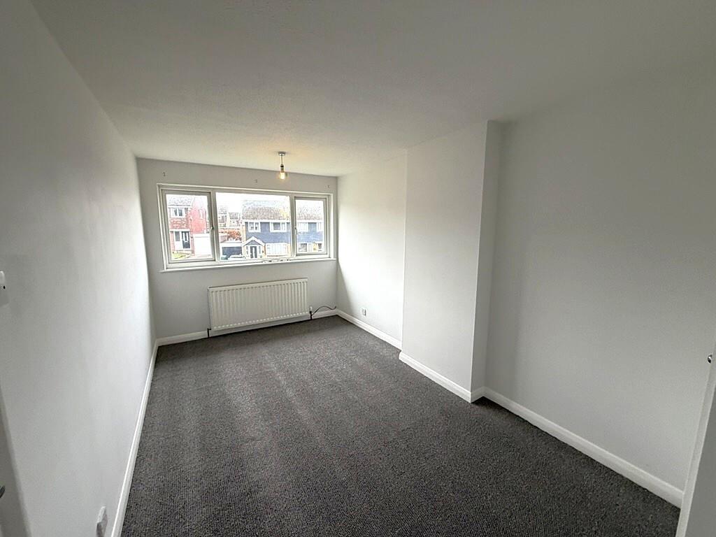 Bright rectangular living room with large front...
