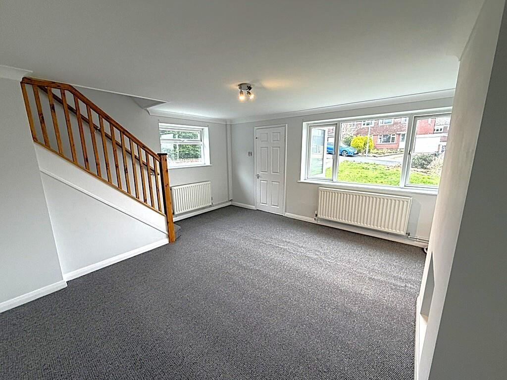 Bright front living room with big window and ne...