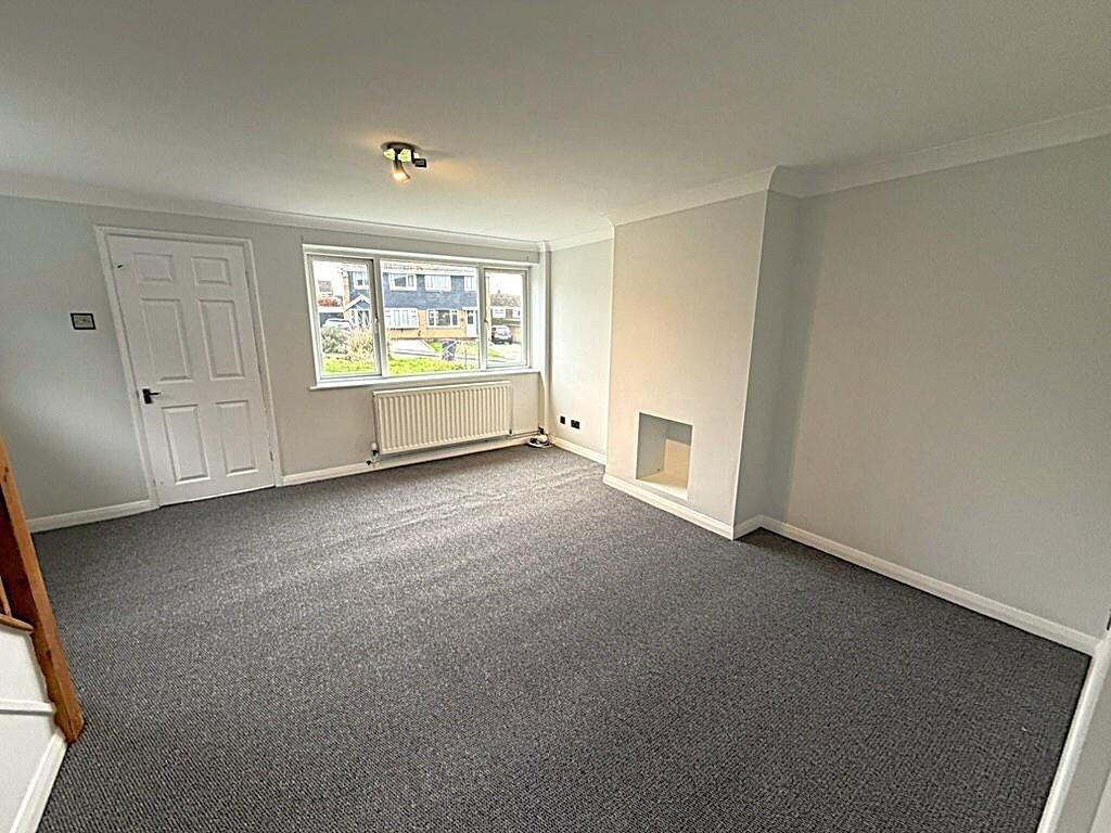 Bright, spacious living room with large window...