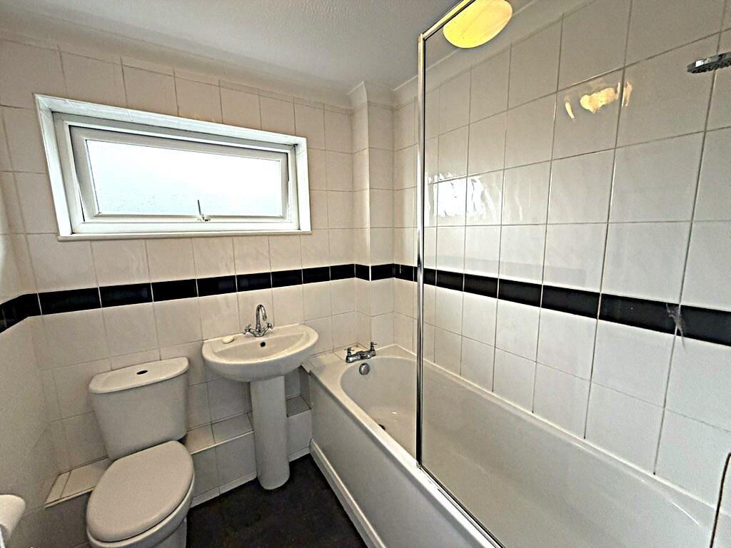 Bright modern bathroom with bathtub and shower...