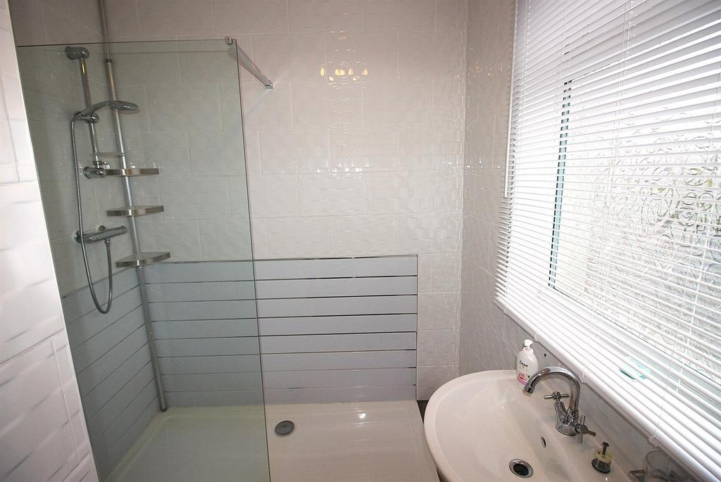 Bright modern bathroom with walk-in shower...
