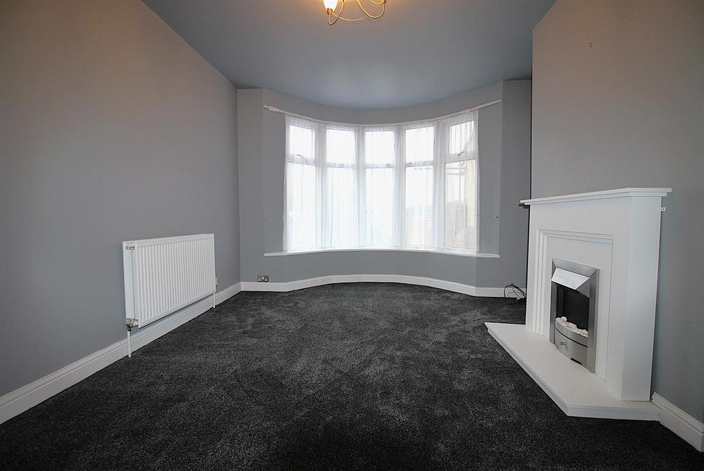 Spacious bay-window living room with fireplace...