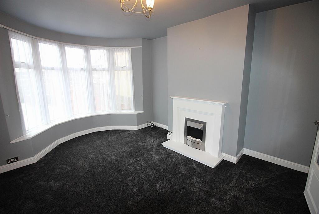 Bright bay-window living room with fireplace...