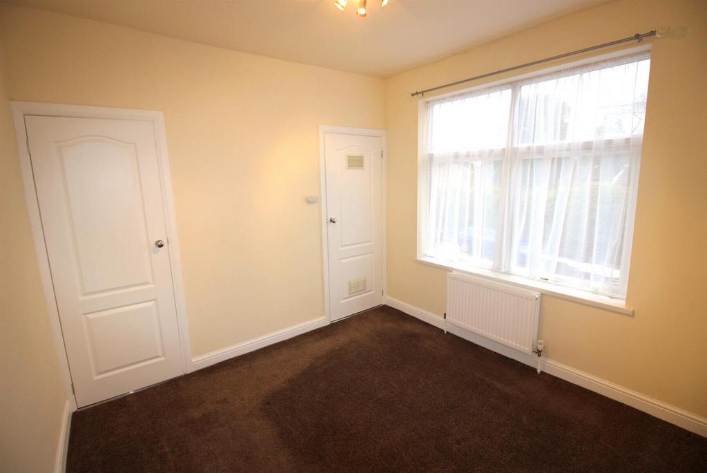 Bright bedroom with large window and neutral de...