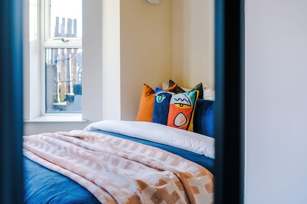 Bright, neatly styled bedroom with a cosy doubl...