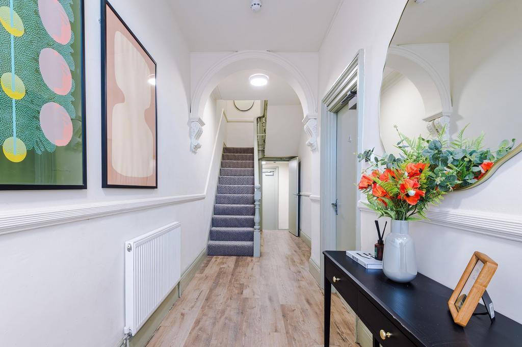 Bright, welcoming hallway with decorative archw...