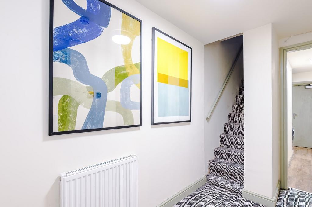 Bright, modern hallway with patterned stair car...