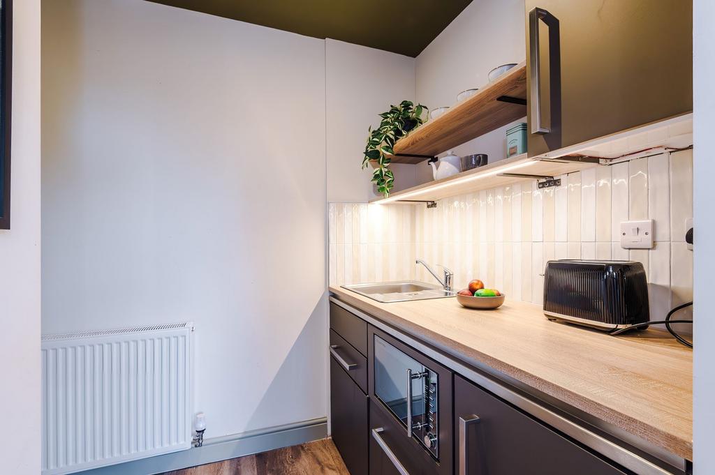 Modern compact kitchen with wood-effect worktop...