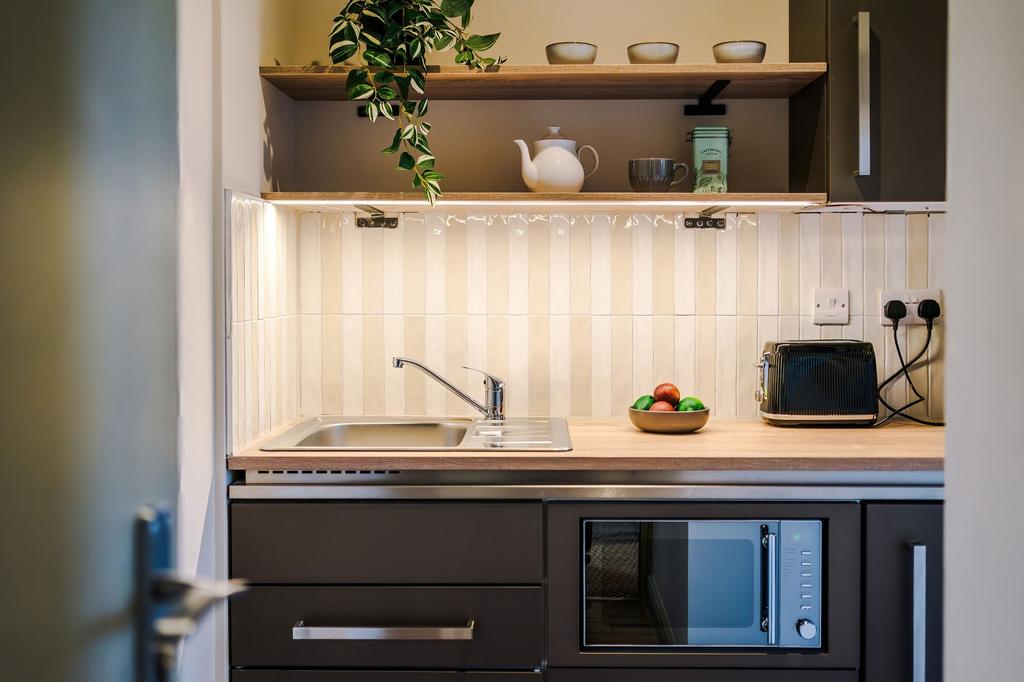 Bright, modern kitchenette with a stainless ste...