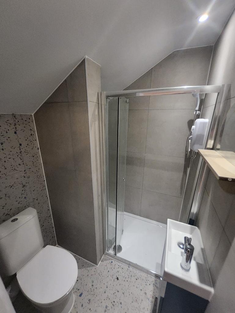 Modern tiled bathroom with shower and fittings...