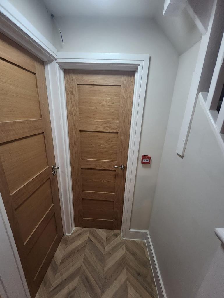 Bright, modern hallway with wood doors...
