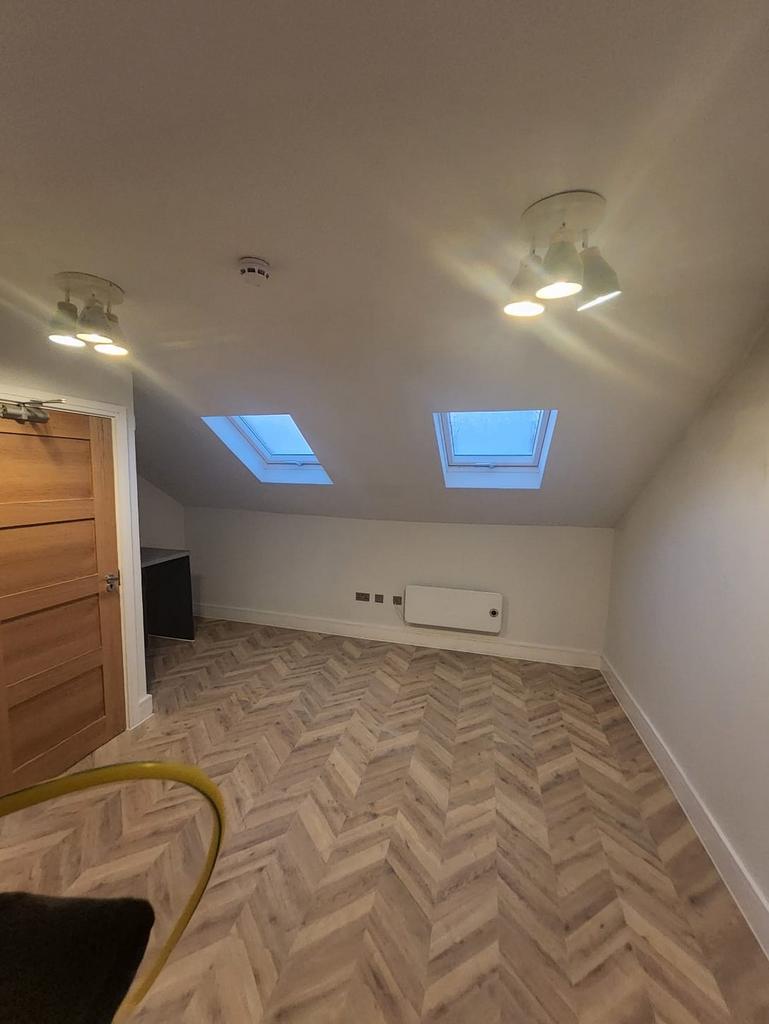 Bright attic-style bedroom with skylights...