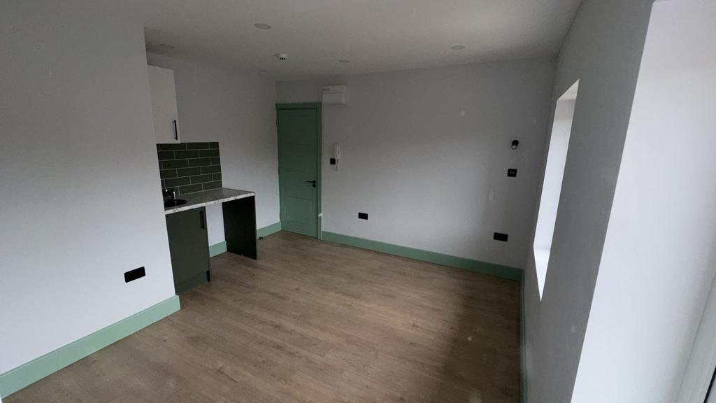 Bright open-plan living area with kitchenette...